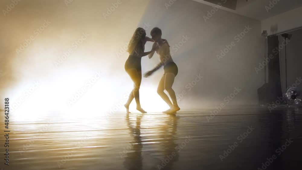 sexy dancers dancing contemporary on dark background with copy space sexy dancers dancing contemporary on dark background with copy space