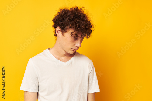 red-haired guy in a white t-shirt on a yellow background © Tatiana