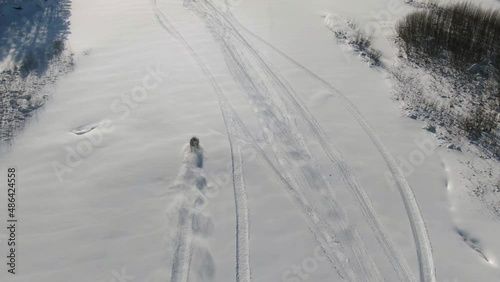 snowmobile driving at high speed drone shooting, riding on the river, tracking effect.