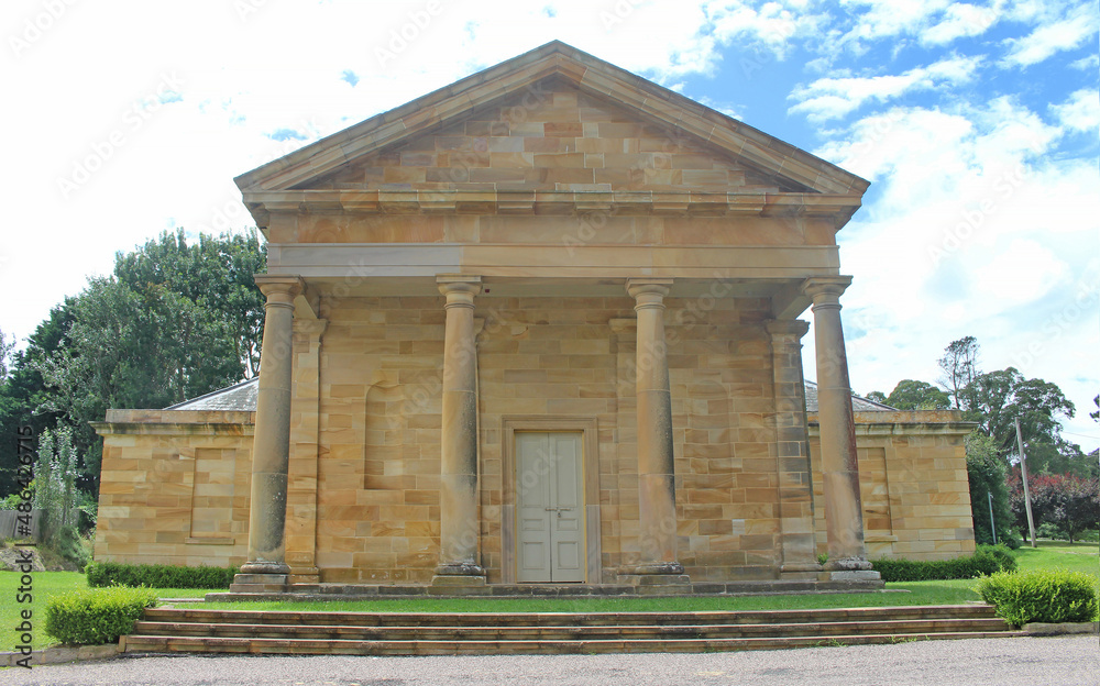 The front of historic sandstone Berrima Courthouse. Built in the Regency Style. The facade consists of four Doric columns with classic Greek bases and capitals