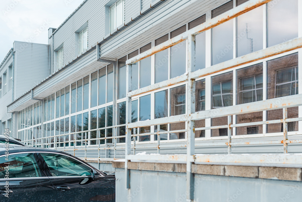 Fototapeta premium gray exterior aluminum panels facade with windows on industrial factory building.