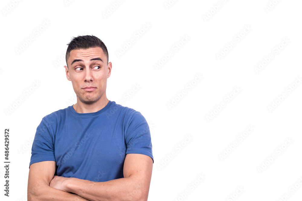 Man with his arms crossed looking aside with distrust Man with his arms crossed looking aside with distrust