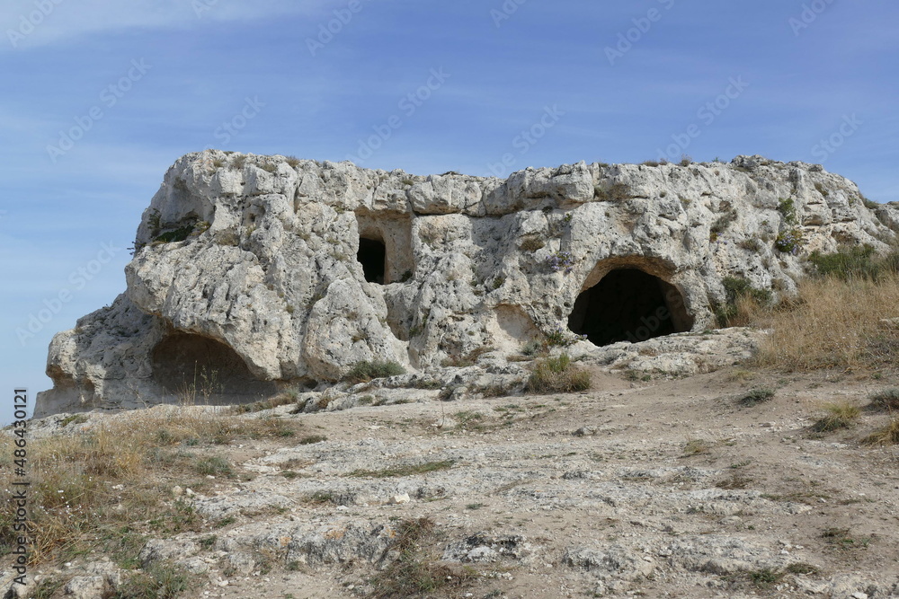 Sant'Agnese rupestrian church in Murgia Materana Park with an arched entrance carved into the rock introducing in the cave
