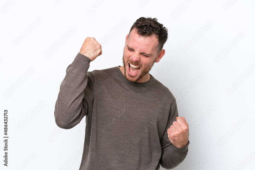 Young Brazilian man isolated on white background celebrating a victory Young Brazilian man isolated on white background celebrating a victory
