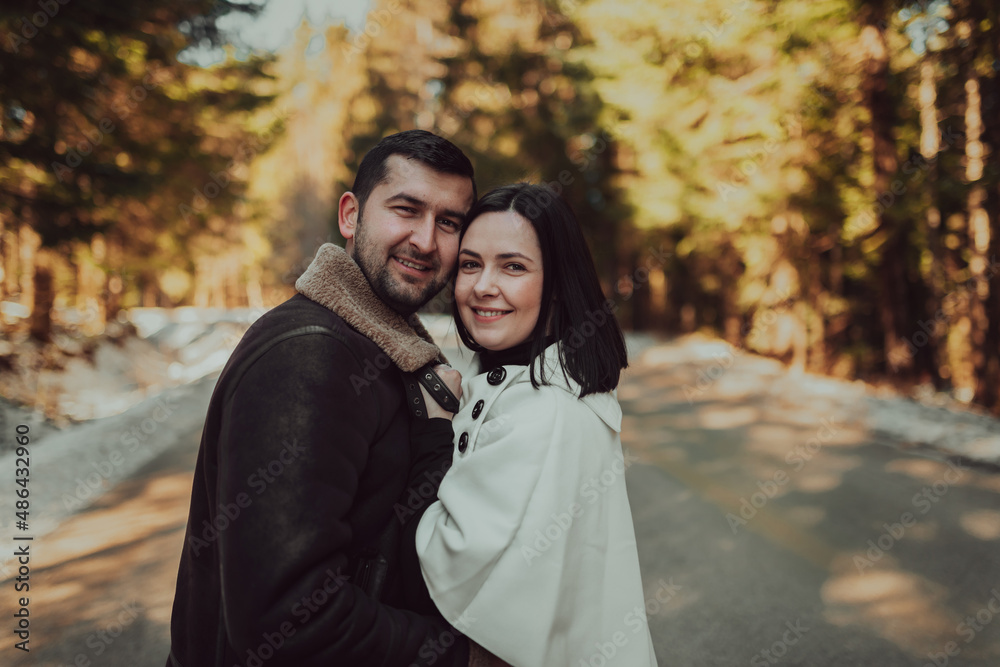 Portrait of handsome man hugging his loving wife on a winter day. Selective focus. Portrait of handsome man hugging his loving wife on a winter day. Selective focus.