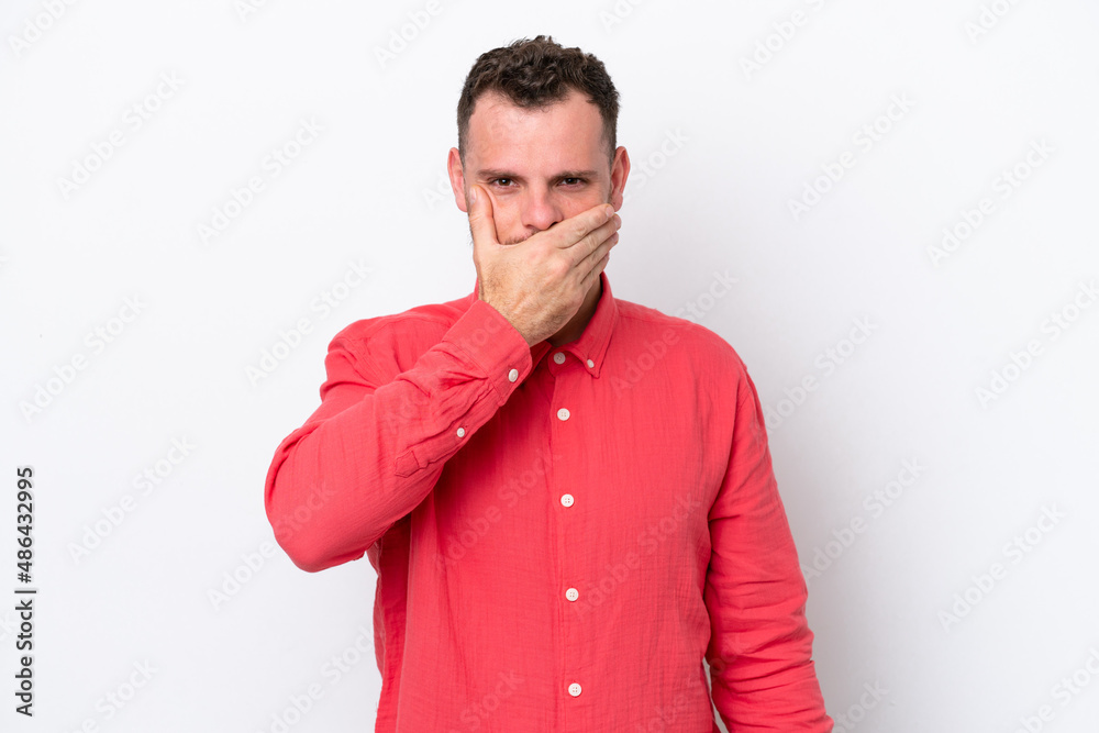 Young Brazilian man isolated on white background covering mouth with hand Young Brazilian man isolated on white background covering mouth with hand