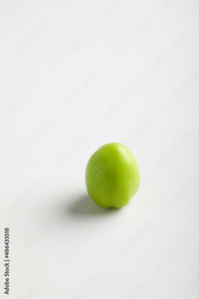 green tomato on white background. green tomato on white background.