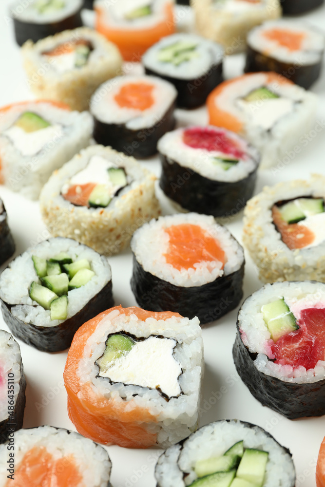 Concept of tasty food with sushi rolls on white background