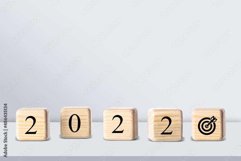 The calendar year 2021 changed to 2022 with the goal and successful concept. wooden cube blocks The calendar year 2021 changed to 2022 with the goal and successful concept. wooden cube blocks