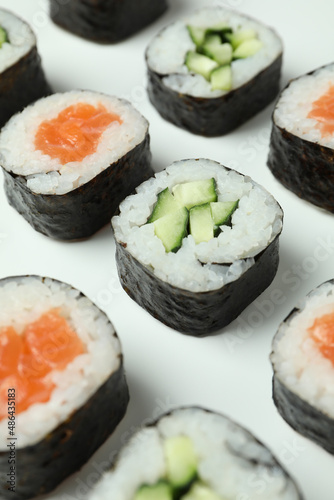 Concept of tasty food with sushi rolls on white background