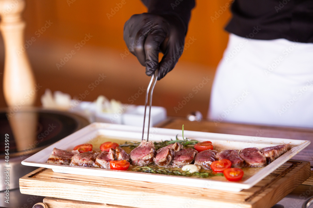 the chef prepares a beef steak