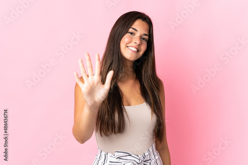 Young brazilian woman isolated on pink background counting five with fingers