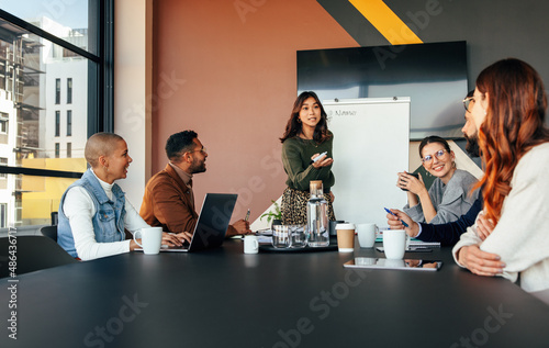 Young businesswoman giving a presentation  in a boardroom photo