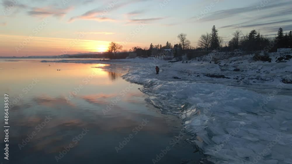Water reflecting sunset light, ice formations on the shore, winter landscape Lake Superior Water reflecting sunset light, ice formations on the shore, winter landscape Lake Superior
