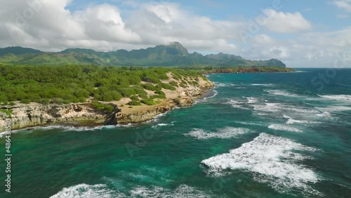 Aerial Tracking Shot Moving Right on a Sunny Beautiful Day at Shipwreck Beach, Hawaii photo