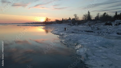 Water reflecting sunset light, ice formations on the shore, winter landscape Lake Superior photo