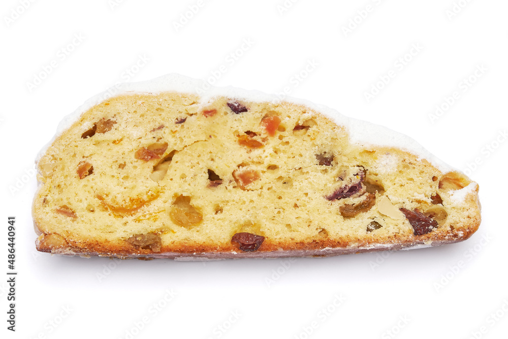 Slices of Traditional Christmas stollen cake with marzipan and dried fruit isolated on white background