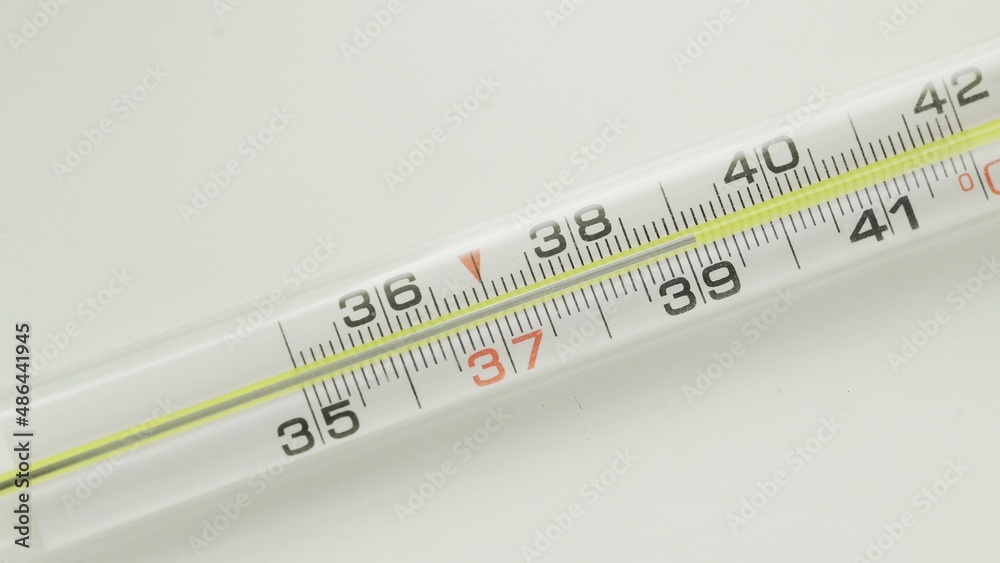 A close-up of a glass mercury thermometer shows a low temperature A close-up of a glass mercury thermometer shows a low temperature