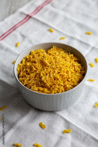 Healthy Dry Farfalline Pasta in a Bowl, side view.