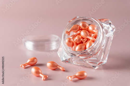 Single-dose serum capsules with active ingredients in a crystal shape container. Skin care and beauty products.