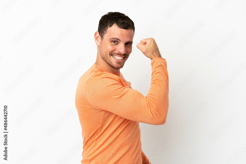 Brazilian man over isolated white background doing strong gesture Brazilian man over isolated white background doing strong gesture