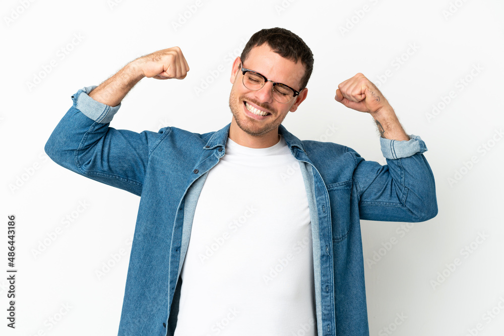 Brazilian man over isolated white background doing strong gesture Brazilian man over isolated white background doing strong gesture