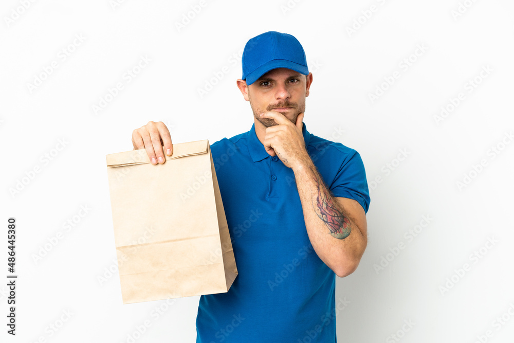 Brazilian taking a bag of takeaway food isolated on white background thinking Brazilian taking a bag of takeaway food isolated on white background thinking