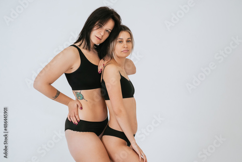 Two diverse models wearing underwear stand side to the camera