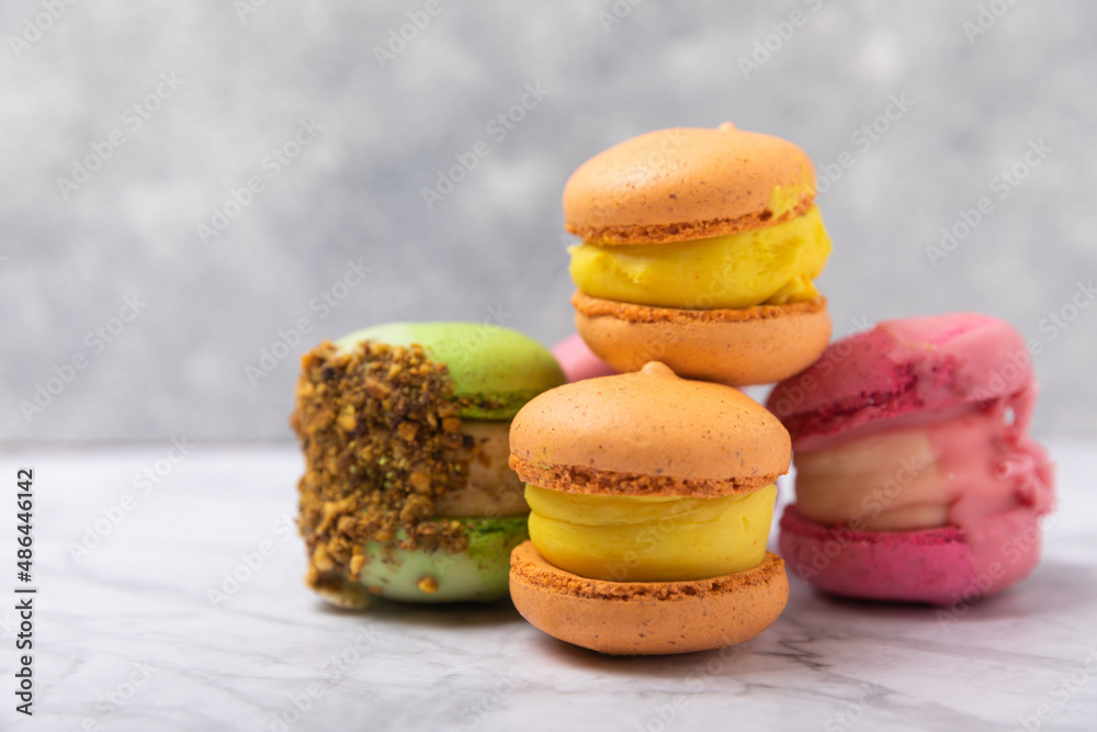 Tasty macarons on a marble background. colorful almond berry cookies.Culinary and cooking concept.Side view.Copy space.Place for text