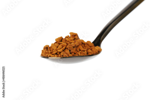 spoon with granulated instant coffee close-up isolated on white background.