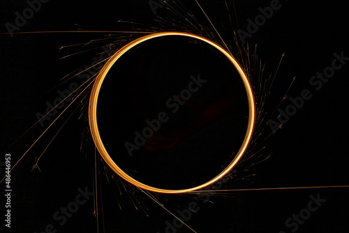 Circular lights with sparks on a black background photo