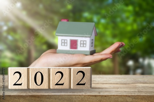 Small house model with number 2022, concept to save money buying house, real estate and property concept.