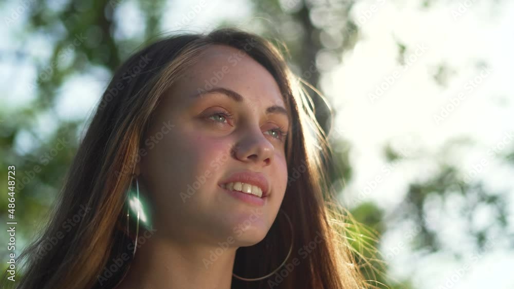Portrait of a happy girl. Teenager smiling in the park. Attractive smile of a young girl. Active lifestyle teenager. Girl model smiling in the sun in the park. Female beauty in the sun in nature Portrait of a happy girl. Teenager smiling in the park. Attractive smile of a young girl. Active lifestyle teenager. Girl model smiling in the sun in the park. Female beauty in the sun in nature