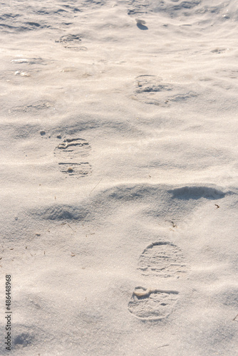 footprints on the snow under sunlight close-up