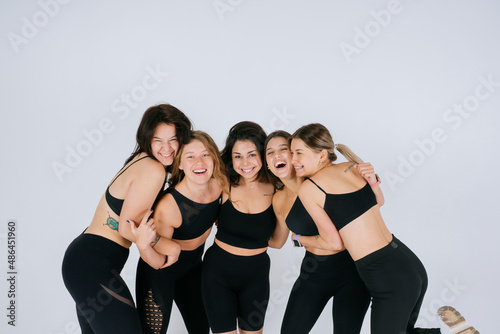 diverse models laughing, enjoying time together, look at camera