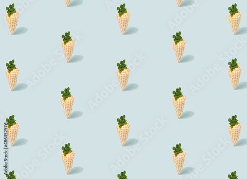 Cute toy carrots pattern on a light blue background. Springtime, Easter minimal template.