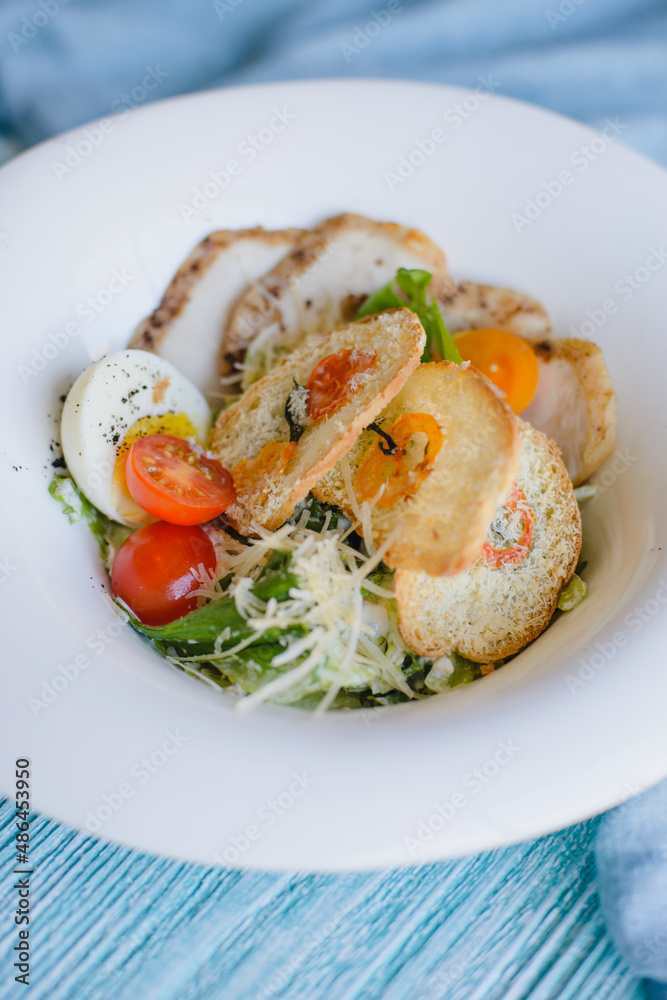 Fresh Caesar salad with croutons, cream and cheese