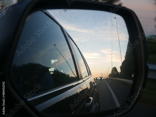Car Mirror looking on Highway Sunset Sunrise