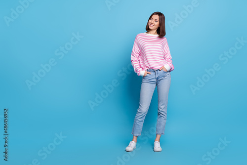Photo of funny adorable lady dressed pink pullover walking looking empty space isolated blue color background