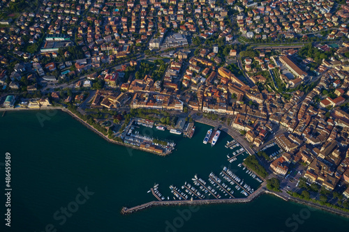 Desenzano, lago di Garda view by drone. Desenzano del Garda in italy. Italian resorts on Lake Garda. Top view of the boat parking on the lake. Aerial view of Desenzano del Garda.