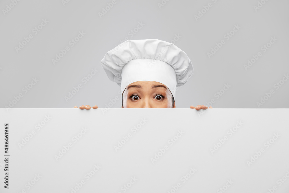 cooking, advertisement and people concept - scared female chef peeking out from behind white board over grey background cooking, advertisement and people concept - scared female chef peeking out from behind white board over grey background