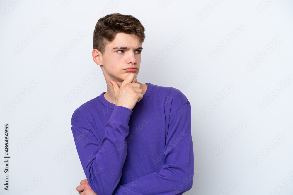 Teenager Russian man isolated on white background and looking up Teenager Russian man isolated on white background and looking up