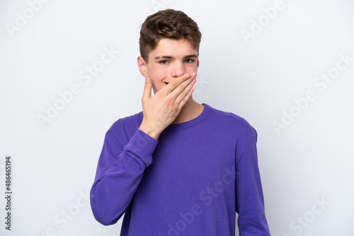 Teenager Russian man isolated on white background happy and smiling covering mouth with hand © luismolinero