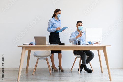Portrait Of Colleagues In Face Masks Working At Office Together