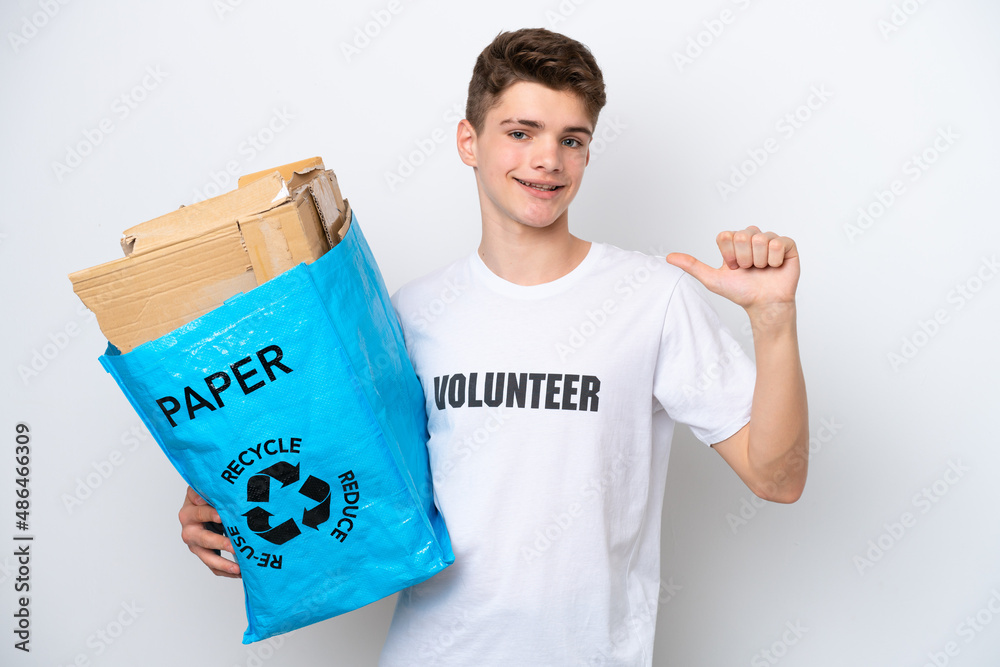 Teenager Russian man holding a recycling bag full of paper to recycle isolated on white background proud and self-satisfied Teenager Russian man holding a recycling bag full of paper to recycle isolated on white background proud and self-satisfied