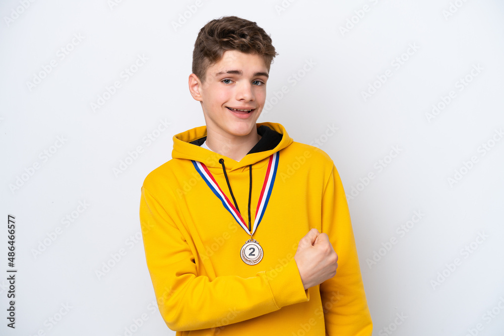 Teenager Russian man with medals isolated on white background celebrating a victory Teenager Russian man with medals isolated on white background celebrating a victory