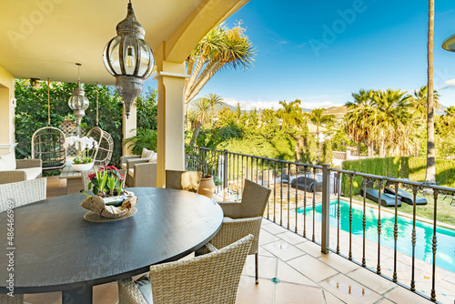 a image of a dining terrace area alongside a pool in a villa along the Mediterranean    © josehidalgo87