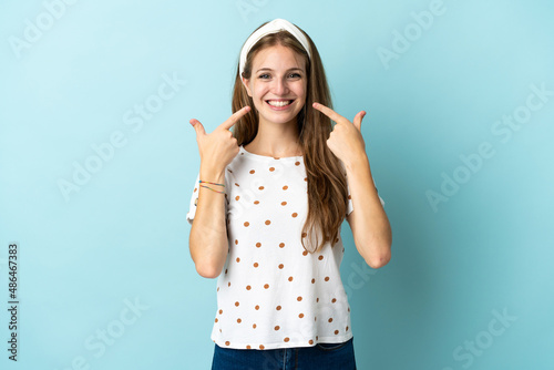Young caucasian woman over isolated background giving a thumbs up gesture