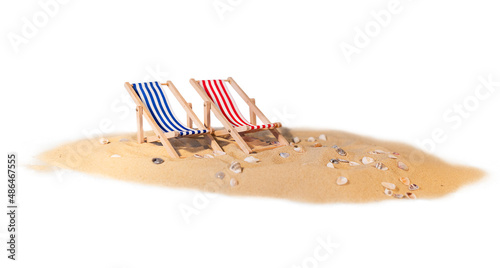 Schilderij op canvas Sand with seashells and sun loungers on a white background