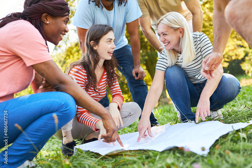 Group of young people geocaching as a scavenger hunt photo